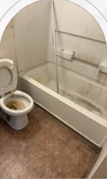 Dirty bathtub and toilet before cleaning