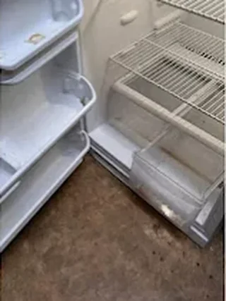 Refrigerator with grimy door shelves before cleaning
