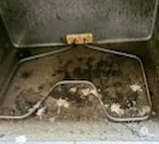 Oven interior with baked-on grease before cleaning
