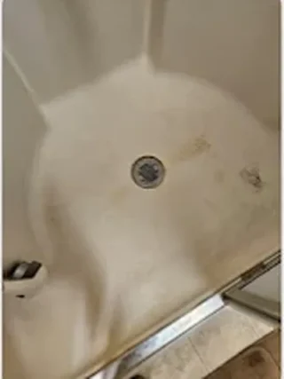 Shower base with soap scum before cleaning